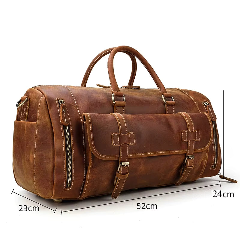 The Weekender 20 Leather Travel Bag is a spacious brown bag made from genuine cowhide, featuring two handles and multiple zippered pockets. It measures 52x23x24cm and includes stylish buckles on the front for added flair.