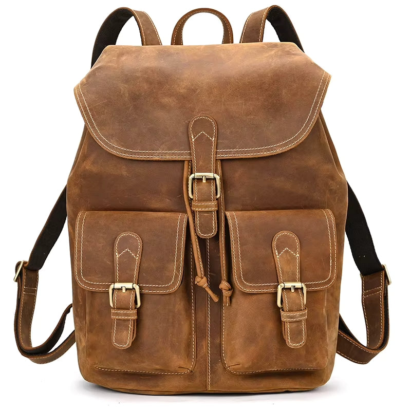 Introducing the Vintage Leather Backpack, meticulously crafted from authentic cowhide leather. This timeless piece features a flap closure and two adjustable straps for comfort. The front is adorned with two buckled pockets and decorative stitching, imparting a rustic charm. Finished with brass hardware detailing, it's ideal for carrying your travel essentials.