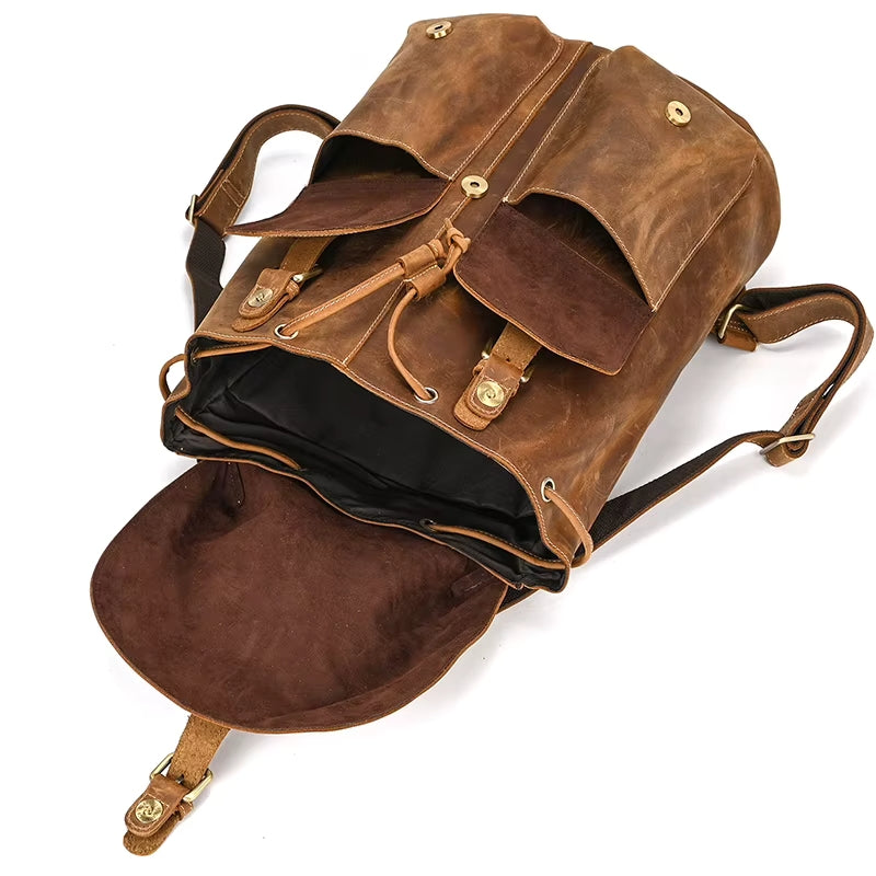 The Vintage Leather Backpack, made from authentic cowhide leather, boasts convenient pockets ideal for organizing all your travel necessities.