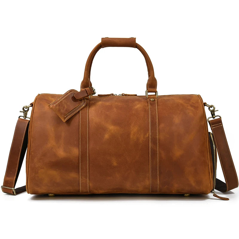 A stylish brown Weekender 24 Duffle Bag crafted from genuine cowhide leather, featuring a handle on top and a detachable shoulder strap. Perfect for travelers, the bag includes a luggage tag attached to one of the handles and brass hardware detailing.