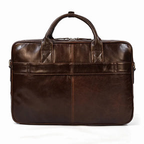 The Leather 16" Briefcase is a professional accessory crafted from genuine cow leather. It features two handles and a robust construction, combining sleek design with visible stitching and a glossy finish. The front includes a horizontal seam with minimal decoration, complemented by an adjustable strap for added convenience.