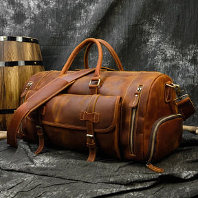 Weekender 20 Leather Travel Bag with shoe compartment, multiple pockets, and alloy hardware; luxurious mens leather duffle bag on display.