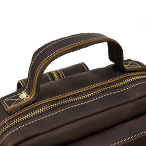 Close-up of a genuine cowhide Leather Travel Daypack Shoulder Bag's handle and zipper. The handle features visible light brown stitching with metal rivets securing it to the bag. The zipper is partially unzipped, exposing the top part of this versatile daypack. The leather exhibits a slightly worn texture.