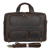 The Leather 17" Business Travel Briefcase is crafted from genuine leather and includes multiple zippered compartments, two top handles, and an adjustable shoulder strap. It boasts a vintage look with visible stitching and metal hardware elements, complemented by a dedicated laptop compartment for enhanced functionality.