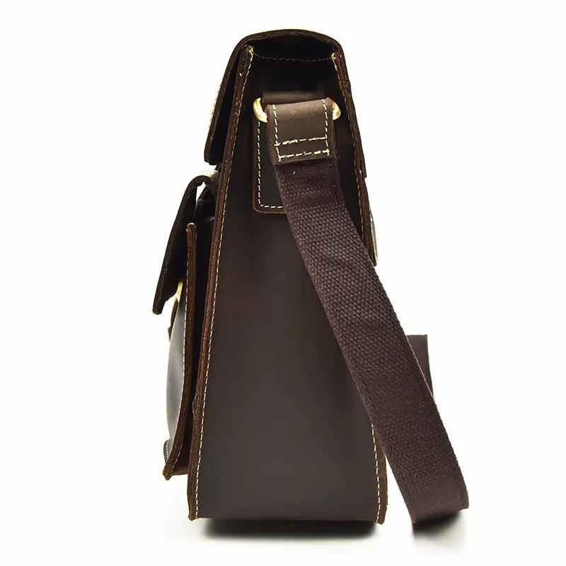 Side view of the Leather Business Travel Shoulder Bag in dark brown genuine cowhide leather, showcasing its sleek design with contrasting stitching. The bag includes a brown adjustable shoulder strap secured by gold-tone alloy hardware and features a front flap. The smooth finish accentuates the sophistication of its craftsmanship.