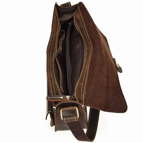 The Vintage Shoulder Bag, crafted from genuine cowhide leather with beige stitching, is partially open, revealing a well-organized interior with multiple compartments. The lifted flap showcases the side profile and an adjustable shoulder strap with a brass buckle—ideal for business trips.