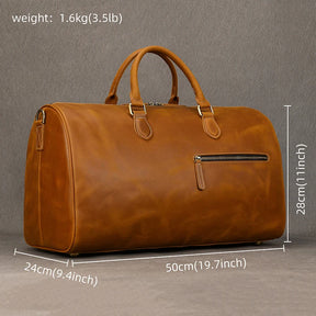 The Leather Travel Duffle, crafted from vintage tan genuine leather, includes a top handle and front zippered pocket. Ideal for travel, it measures 50cm x 28cm x 24cm and weighs 1.6kg.