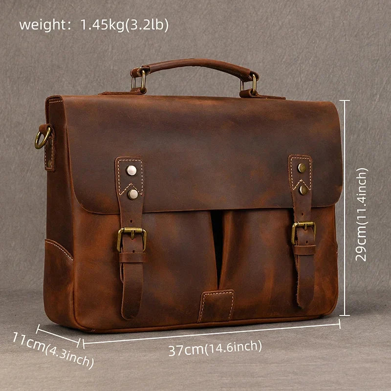 The Leather 14" Briefcase Shoulder Bag is a brown leather satchel made from genuine cowhide. It features a top handle and two front buckle straps. With dimensions of 37cm (14.6 inches) in width, 29cm (11.4 inches) in height, and 11cm (4.3 inches) in depth, this professional-style leather briefcase weighs 1.45 kg (3.2 lb).