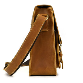 Side view of the Vintage Shoulder Bag in brown leather with beige stitching. This genuine cowhide leather bag comes with a long adjustable strap secured with metal hardware. The texture of the bag appears smooth, with the strap positioned diagonally across the front of the image—ideal for business trips.