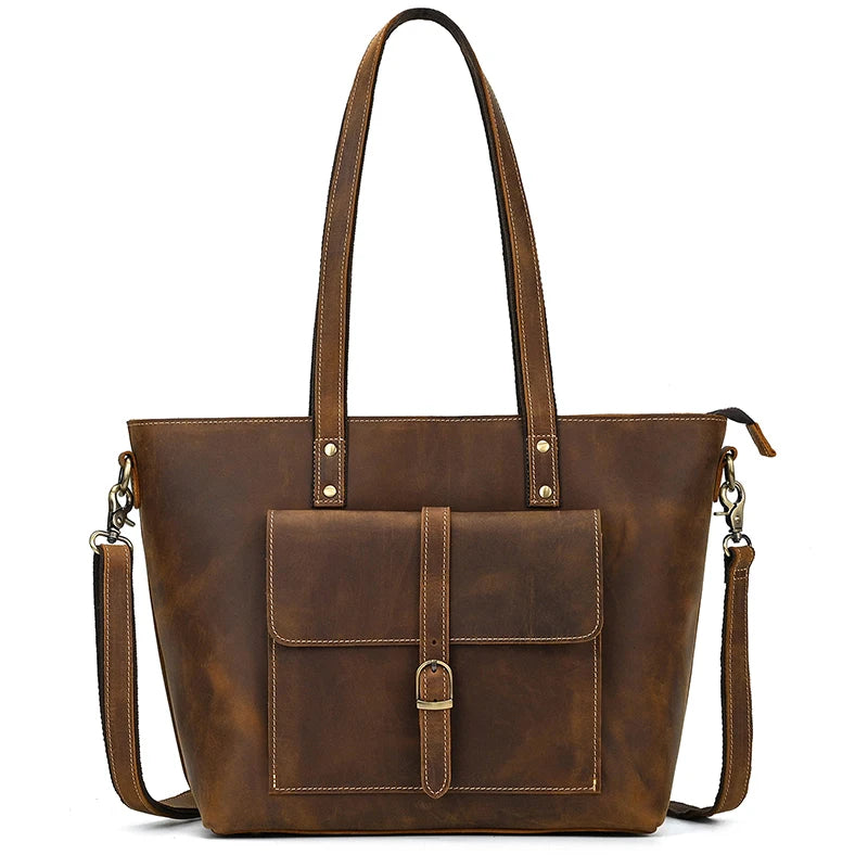 The Genuine Leather Women's Tote Bag – Large Capacity Business Handbag boasts a vintage-style design with a brown leather finish, long straps, and a front pocket accented by a small buckle. It features a structured silhouette, spacious interior, and includes a detachable shoulder strap secured by metal clasps. Perfect for any occasion, it's the ideal choice for those seeking style and functionality in one elegant tote.