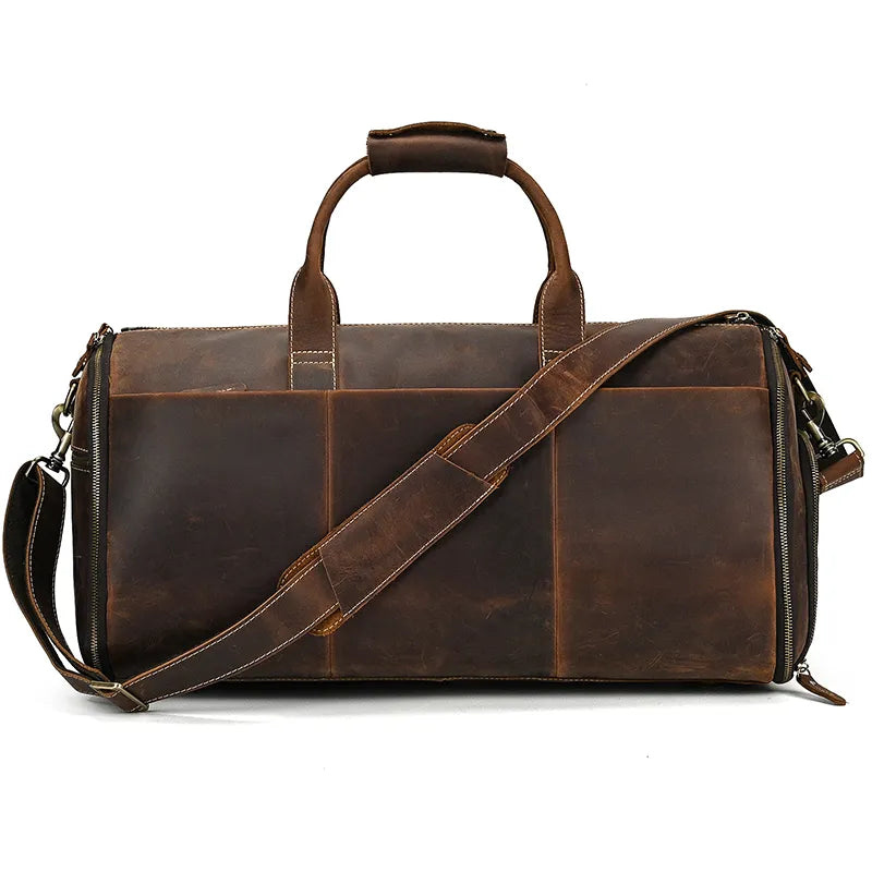 The Luggage 22 Leather Travel Duffle Bag is a stylish brown leather travel duffle bag featuring two sturdy handles and a removable strap. It boasts subtle stitching and a classic, rustic design. Crafted from genuine leather, it has a slightly worn look that enhances its vintage appeal.