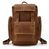 The Vintage Leather Travel Backpack is made from genuine cowhide leather and has a rich, smooth finish. It includes multiple compartments, a laptop compartment, a front pocket with flap and buckle closures, side zippers, and adjustable shoulder straps.