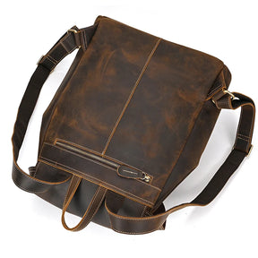 The Genuine Leather Vintage Backpack is a men's accessory made from authentic leather, equipped with adjustable straps and a front zipper pocket. Its sleek, minimalist design and slightly weathered, vintage appearance make it a perfect match for a casual look.