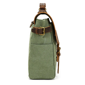 Side view of the Canvas & Leather Vintage Messenger Bag, featuring a green canvas body, genuine leather straps, and brass buckles. This men's bag has an external pocket and a padded handle, combining style with functionality.