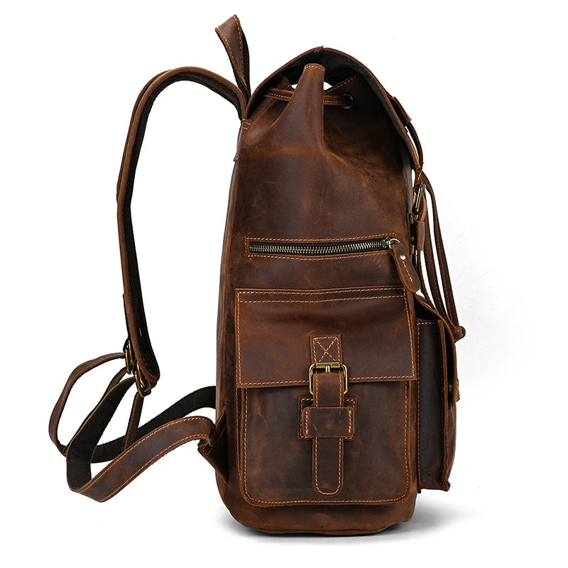 Side view of the Genuine Leather Travel Backpack in light brown, showcasing a vintage design with a buckle-closure front pocket and a zippered vertical pocket above it. The adjustable shoulder straps and distressed appearance, along with prominent stitching details, highlight its rustic style.