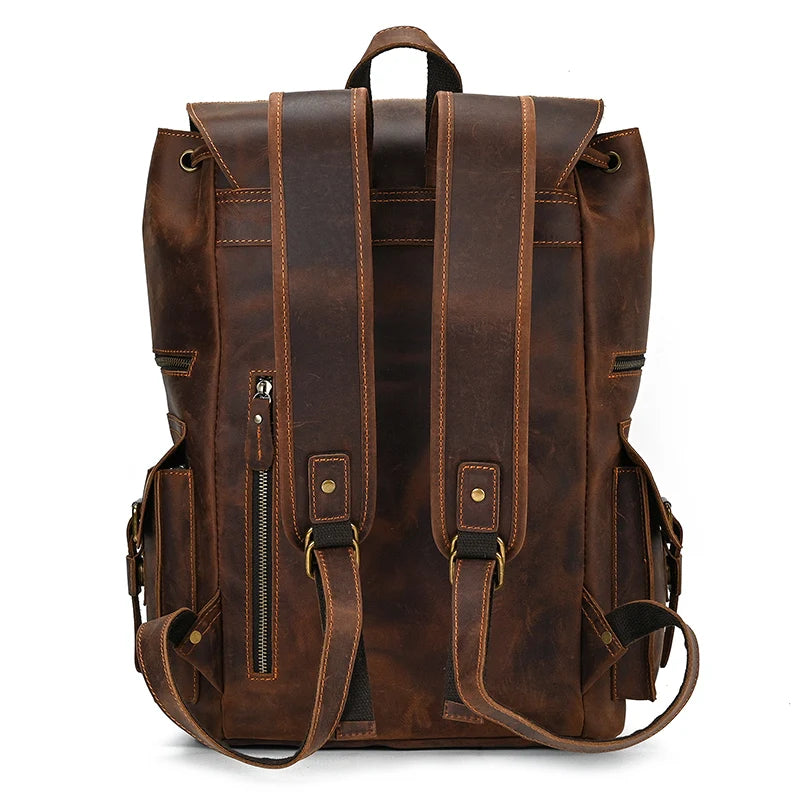 Introducing the Genuine Leather Travel Backpack in Light Brown: This vintage-inspired travel companion features adjustable shoulder straps, a top handle, and multiple functional pockets. The back view highlights two vertical zippered pockets and side compartments with secure buckles. Its rustic appearance is complemented by visible stitching details, making it the perfect durable gear for your travels.