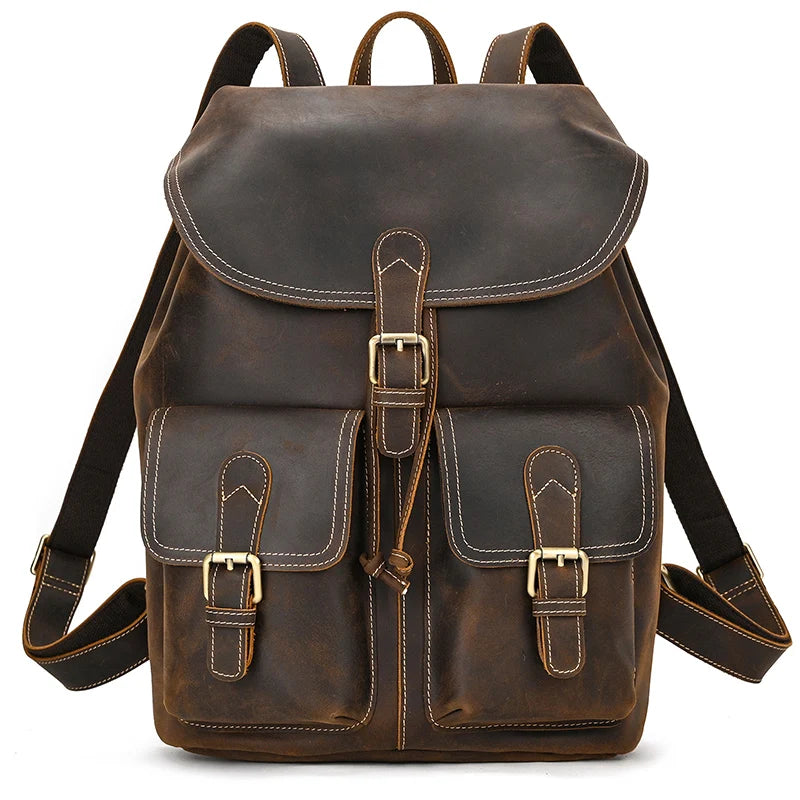 Introducing the Genuine Leather Vintage Backpack: a casual brown softback crafted from genuine leather, adorned with white stitching. It features two front pockets with buckle closures and adjustable shoulder straps for added comfort.