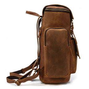 The Vintage Leather Travel Backpack, crafted from genuine cowhide leather, features multiple zippered compartments, a laptop sleeve, and adjustable straps. Its side view highlights a smooth, polished finish with a structured yet spacious design perfect for style and practicality.