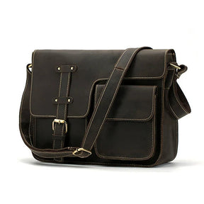 The **Vintage Shoulder Bag** is crafted from genuine cowhide leather in a dark brown finish and features a classic vintage design. It includes a flap closure secured by a buckle strap, two large external pockets with detailed stitching, and an adjustable shoulder strap. This sleek, professional bag is ideal for business trips.