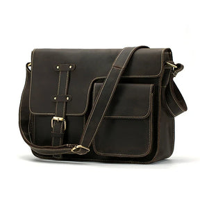 The Leather Business Travel Shoulder Bag is a dark brown leather messenger bag featuring a front flap secured by a strap and buckle. Made from genuine cowhide leather, it boasts high-quality alloy hardware and white stitching. It offers multiple pockets, including a large main compartment and a smaller front pocket, along with an adjustable shoulder strap.