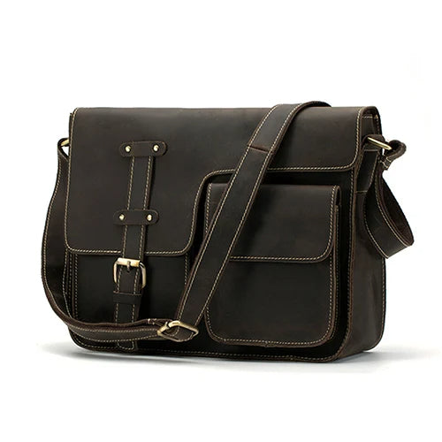 The Leather Business Travel Shoulder Bag is a dark brown accessory made from genuine cowhide leather. It boasts a classic vintage design, highlighted by white stitching detail and durable alloy hardware. This bag features several stitched pockets, an adjustable shoulder strap, and a front buckle closure for added security and style.