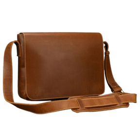 The Vintage Leather Shoulder Bag is crafted from brown genuine cow leather and features a single adjustable strap for shoulder carry. This timeless messenger bag has a smooth surface with minimal stitching and a flap closure, showcasing its elegant, vintage style.