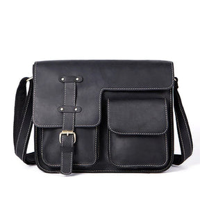 The Leather Business Travel Shoulder Bag combines a sleek and sophisticated black leather design with elegant white stitching accents. Crafted from genuine cowhide leather, it features a front flap that secures with a strap and buckle, complemented by durable alloy hardware. The bag offers ample storage with a large compartment behind the flap and two smaller front pockets for extra organization. Additionally, the adjustable shoulder strap ensures comfortable carrying.