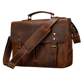 The Leather 14" Briefcase Shoulder Bag is a brown, genuine cowhide leather messenger bag featuring a buckle and strap closure. It comes with a top handle and an adjustable shoulder strap for versatile carrying options. The bag is designed with two small front pockets with button closures and brass hardware accents, making it perfect for a professional look.